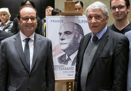 French President Francois Hollande (L) poses with Gilbert Mitterrand, son of the late French President Francois Mitterrand as they unveil a commermorative stamp marking the 100th anniversary of the birth of the late president Mitterrand, at the Louvre Museum in Paris, France, October 26, 2016. REUTERS/Ian Langsdon/Pool