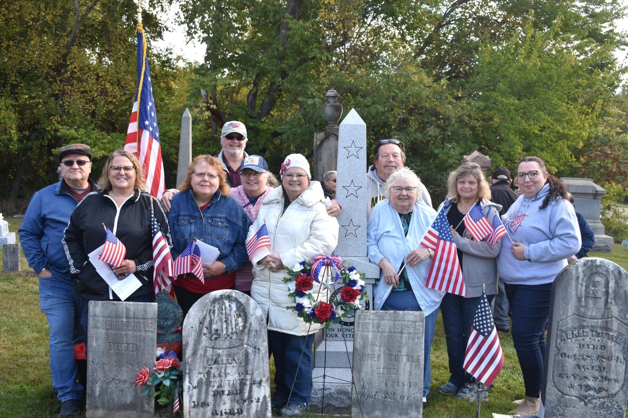 Several Tuttle family members and descendants gather around a new, 6-foot tall, granite monument that was dedicated Saturday in Weston Village Cemetery. The monument memorializes Revolutionary War veterans, including Joseph Tuttle, who is buried at the cemetery. His headstone can be seen at left. Family members pictured are, from left, Bryan VanDoren, Jill Funk, Pamela Funk-Knight, Karen Shirley, David Dawn, Susan Funk-Dawn, Ruth Rickard, John Wollet, Victoria Wollet and Brittnee Knight.