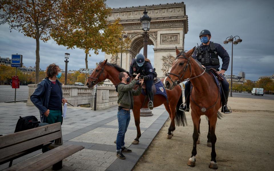 Mounted Police check Parisians attestations, the declaration needed to leave home, on the Champs Elysees on the second day of national lockdown confinement on October 31 -  Kiran Ridley/Getty Images