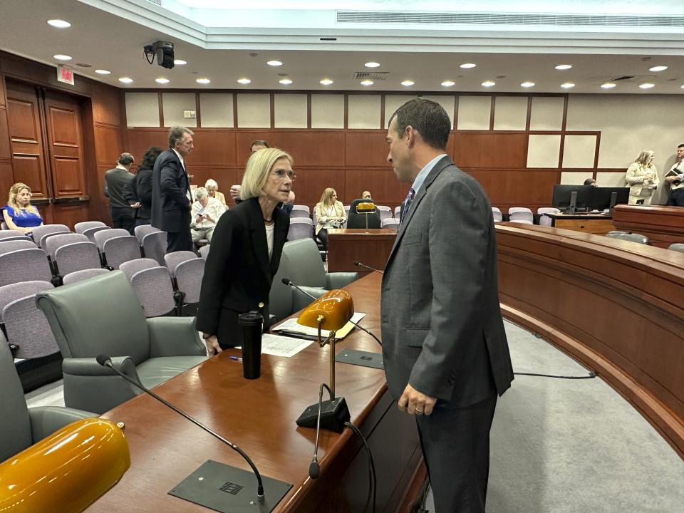 Former Connecticut US attorney, Nora Dannehy speaks with Bridgeport State Rep. Steven Stafstrom before her Wednesday, Sept. 20, 2023, confirmation hearing in her nomination to the Connecticut State Supreme Court at the Legislative Office Building in Hartford, Conn. Dannehy later told state lawmakers she resigned from the Trump-Russia probe because of her concerns with public comments made by then US Attorney General William Barr. (AP Photo/Susan Haigh)