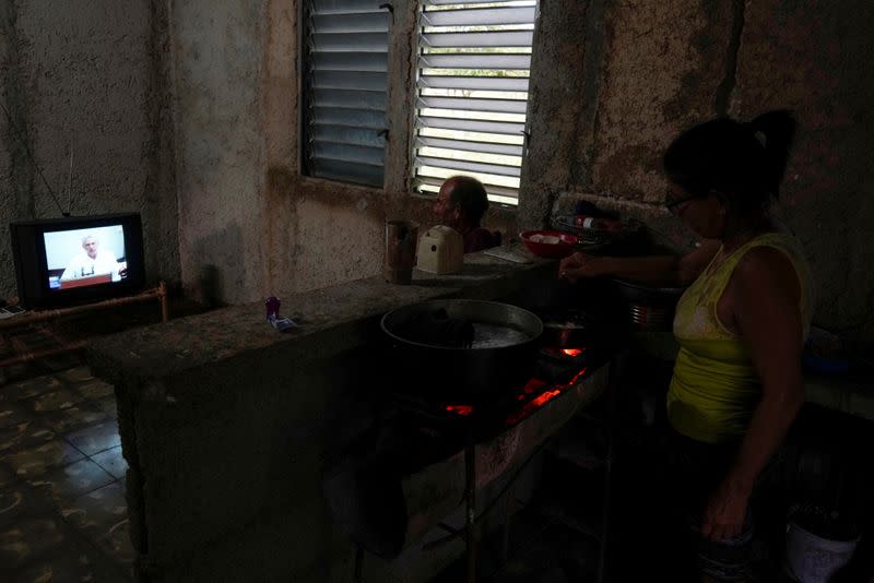 People watch Cuba's President Miguel Diaz-Canel speaking during a local TV news program in Coblet