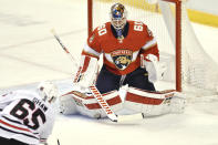 Florida Panthers goaltender Chris Driedger (60) makes a save on a shot by Chicago Blackhawks right wing Andrew Shaw (65) during the first period of an NHL hockey game Sunday, Jan. 17, 2021, in Sunrise, Fla. (AP Photo/Jim Rassol)