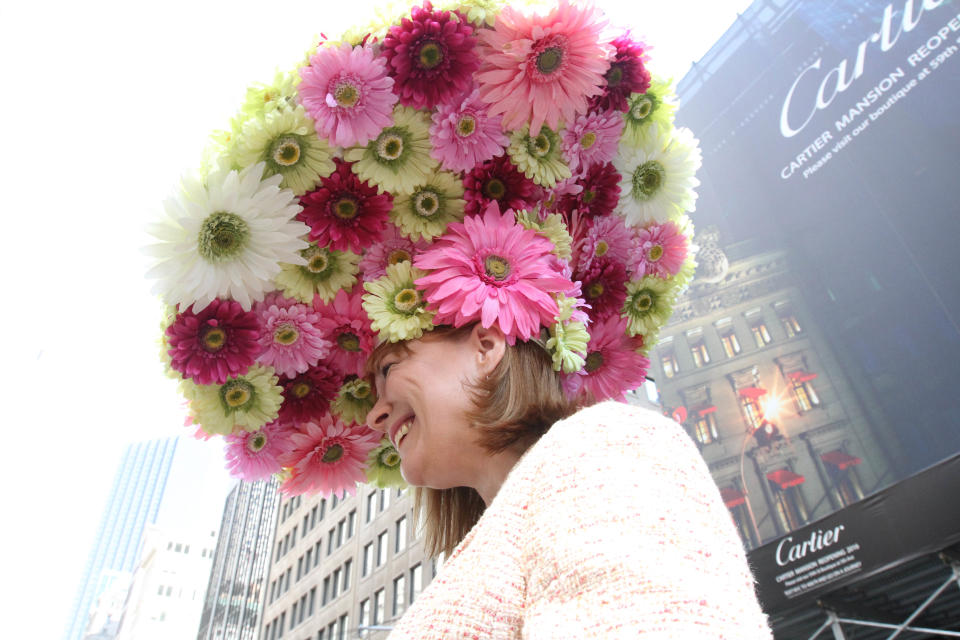 Dressed for the occasion, Michelle White poses for photographs as she makes her way along New York's Fifth Avenue during the Easter Parade, Sunday, April 20, 2014. (AP Photo/Tina Fineberg)