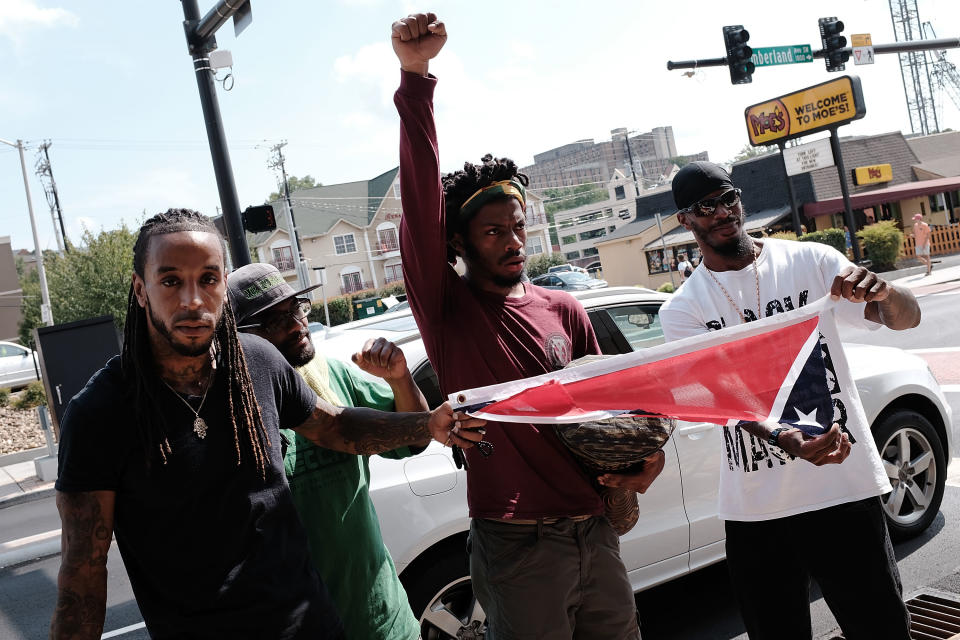 <p>Men hold a torn confederate flag following a demonstration against supporters of a Confederate monument in Fort Sanders on Aug. 26, 2017 in Knoxville, Tenn. (Photo: Spencer Platt/Getty Images) </p>