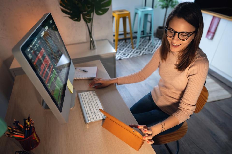 Someone working on multiple screens at the same time.