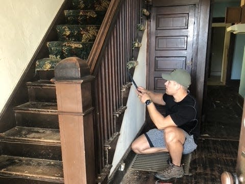 The entryway and staircase when they first bought the house.