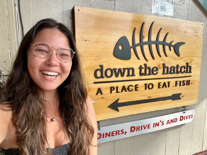 Ashley Probst selfie in front of Down the Hatch sign