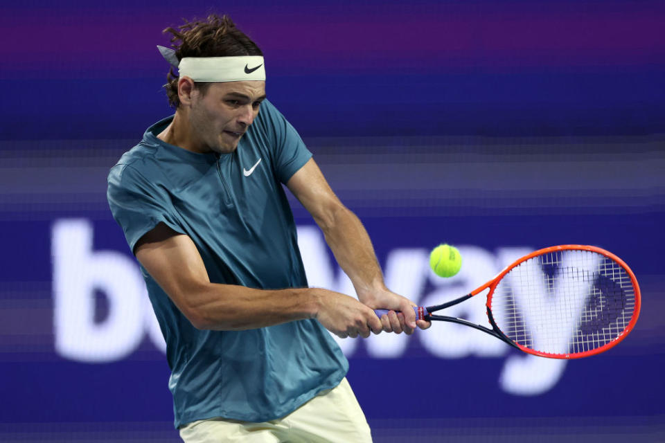 Taylor Fritz of the United States returns a shot to Carlos Alcaraz of Spain during the quarterfinals of the Miami Open at Hard Rock Stadium on March 30, 2023