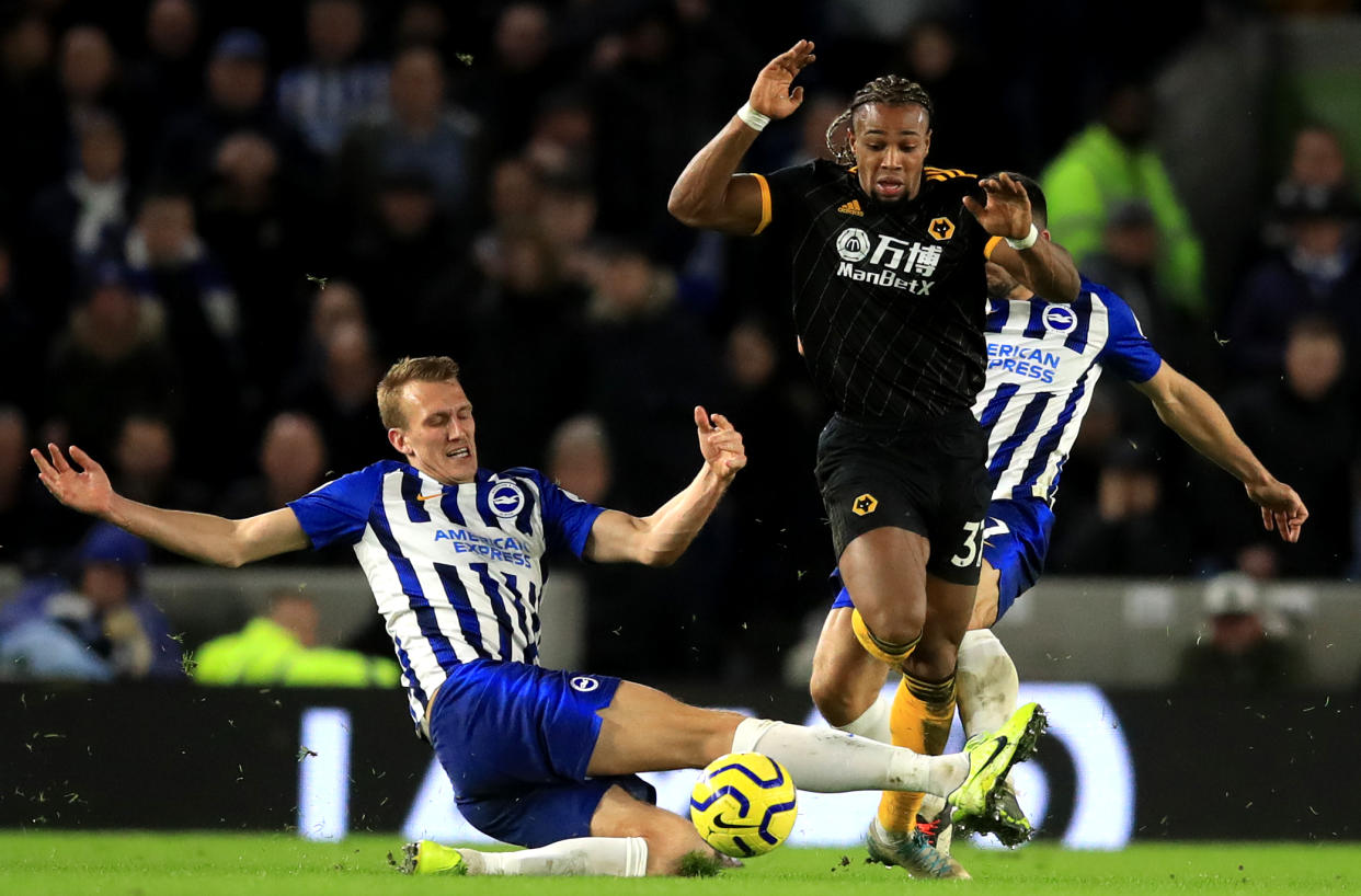 Brighton and Hove Albion's Dan Burn challenges Wolverhampton Wanderers' Adama Traore Brighton and Hove Albion v Wolverhampton Wanderers - Premier League - Amex Stadium 08-12-2019 . (Photo by  Adam Davy/EMPICS/PA Images via Getty Images)