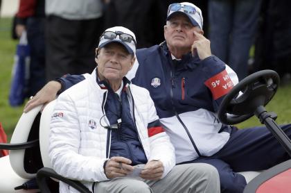 US team captain Tom Watson, left, sits in a buggy and looks at the scoreboard near the 11th hole during the singles match on the final day of the Ryder Cup golf tournament at Gleneagles, Scotland, Sunday, Sept. 28, 2014. Unidentified man at right. (AP Photo/Matt Dunham)