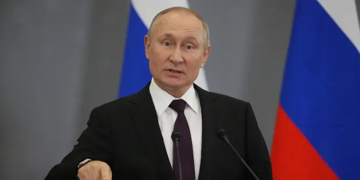 Vladimir Putin speaking and pointing.