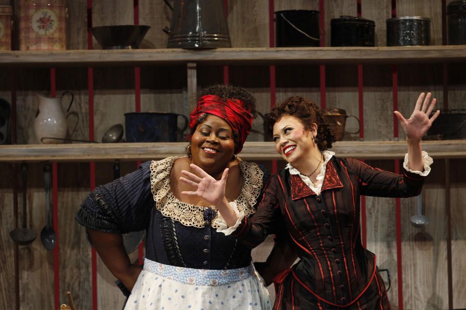 In this photo taken Feb. 9, 2012, Angela Renee Simpson, left, portraying, Queenie, and Alyson Cambridge, portraying Julie Laverne, perform at a dress rehearsal during the first act of the Lyric Opera of Chicago's production of "Show Boat." (AP Photo/M. Spencer Green)