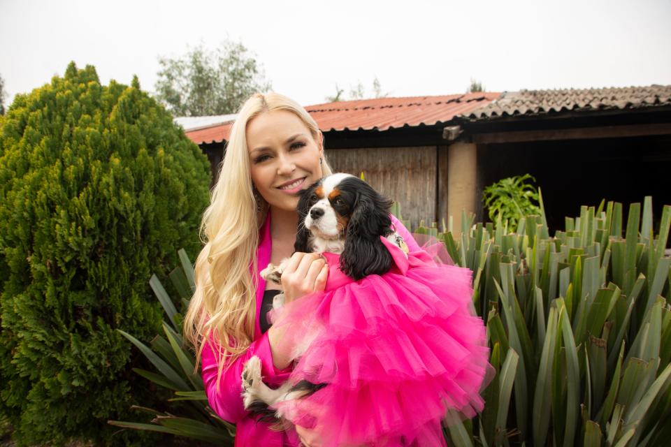 "The Pack" host Lindsey Vonn, with her co-host, her rescue dog Lucy oftentimes coordinate for the series. Lucy's fuchsia is one of Vonn's favorite costumes.