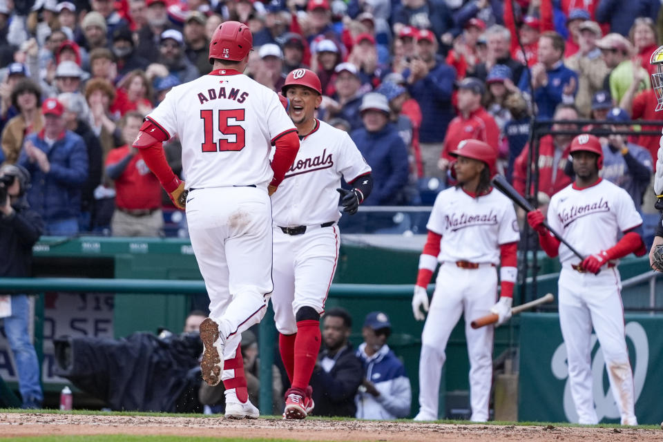 Washington Nationals, Riley Adams celebrates his two-run homer with Ildemaro Vargas during the seventh inning of an opening-day baseball game against the Pittsburgh Pirates at Nationals Park, Monday, April 1, 2024, in Washington. (AP Photo/Alex Brandon)
