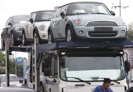 A truck driver prepares to transport BMW's Mini cars in Goyang, north of Seoul, in this June 12, 2013 file picture. REUTERS/Lee Jae-Won/Files