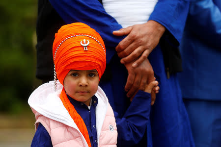 FILE PHOTO: A young Sikh wears a colourful turban as he joins family members at the Vaisakhi Festival, marking the New Year, in Rome, Italy April 14, 2019. REUTERS/Yara Nardi