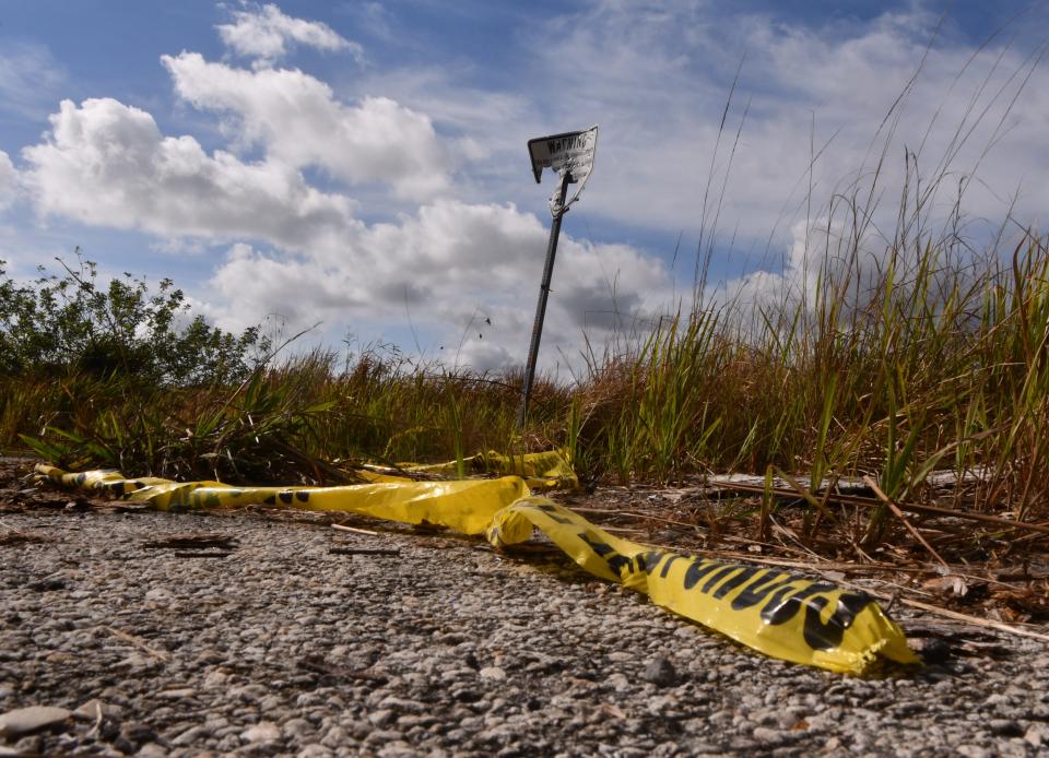 Yellow crime scene tape marks off an area near the intersection of Angora St. SW and Camilo Circle where the Christmas shootings happened in 2022. The Compound is located in the southwestern area of Palm Bay and is a failed development of 12.2 square miles made up of palmettos, pepper trees, wax myrtles and a roads.