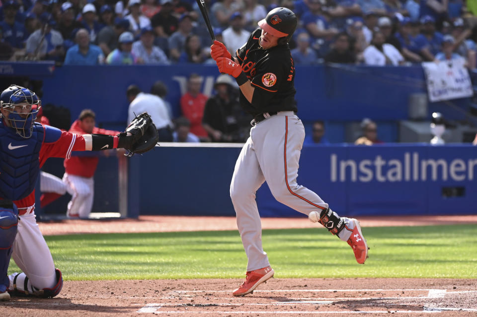 Baltimore Orioles' Ryan Mountcastle is hit by a pitch from Toronto Blue Jays starter Jose Berrios in second-inning baseball game action in Toronto, Saturday, Sept. 17, 2022. (Jon Blacker/The Canadian Press via AP)