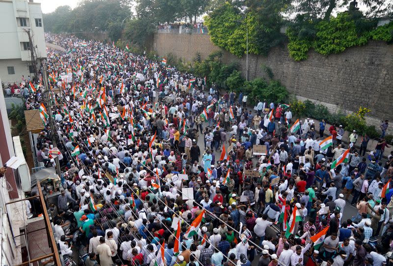 Demonstrators hold placards and flags as they attend a protest rally against a new citizenship law, in Hyderabad