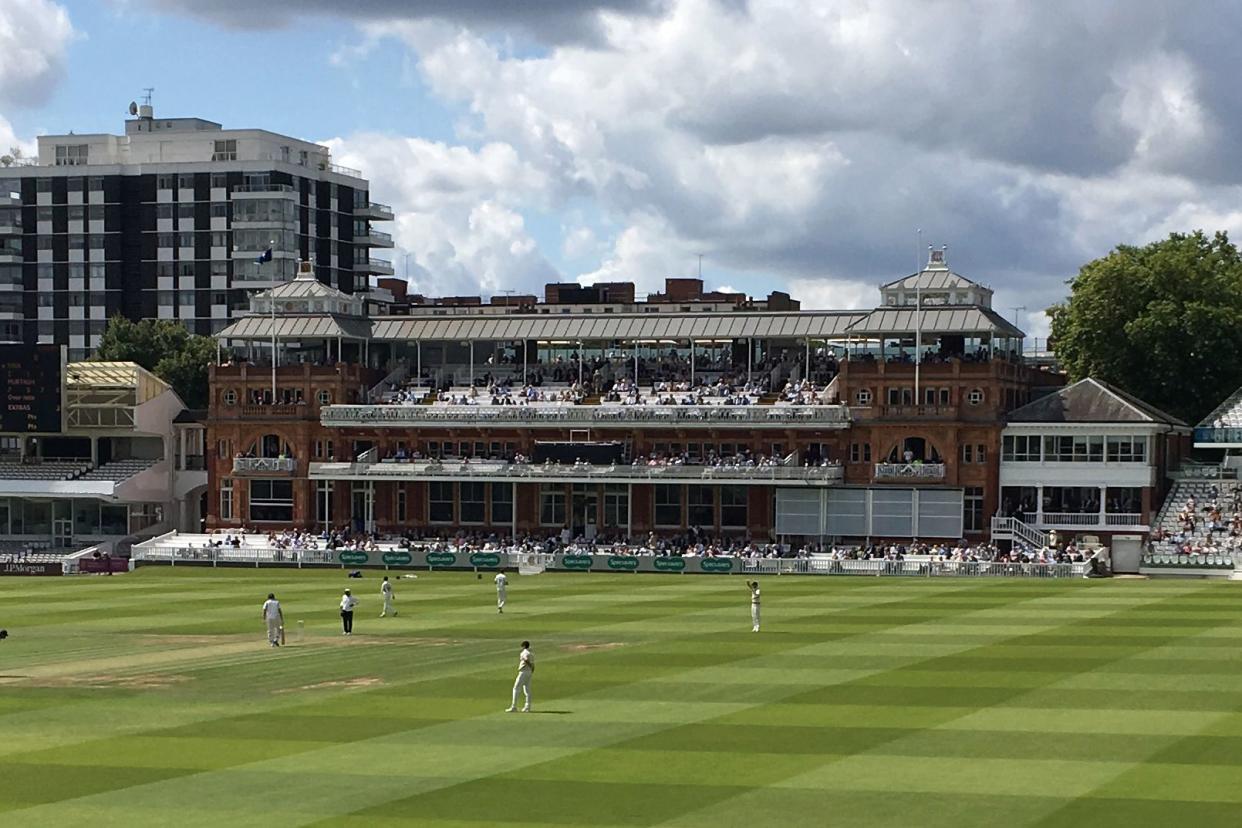 Lord's Cricket Ground during a game on a partly cloudy day.