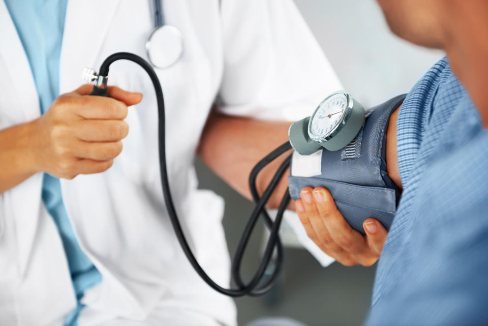 A doctor take a patient's blood pressure