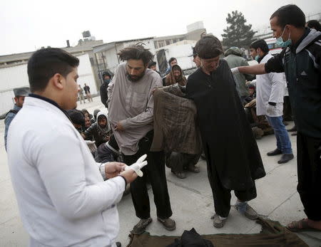 Health workers help to undress people at a newly-opened treatment centre at Camp Phoenix, after a police round up of suspected drug addicts in Kabul, Afghanistan December 27, 2015. REUTERS/Ahmad Masood