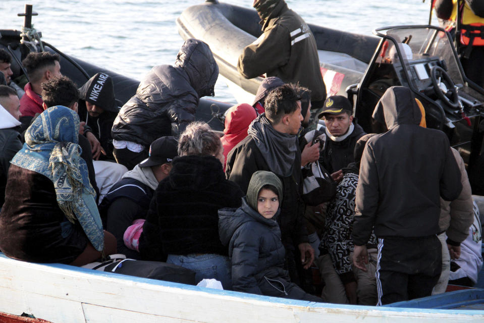 Migrants board a boat after getting stopped by Tunisian Maritime National Guard at sea during an attempt to get to Italy, near the coast of Sfax, Tunisia, Tuesday, April 18, 2023. The Associated Press, on a recent overnight expedition with the National Guard, witnessed migrants pleading to continue their journeys to Italy in unseaworthy vessels, some taking on water. Over 14 hours, 372 people were plucked from their fragile boats. (AP Photo)