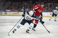 Winnipeg Jets left wing Nikolaj Ehlers (27) tries to maintain possession as he is pressured by Washington Capitals defenseman Dmitry Orlov in the first period of an NHL hockey game, Tuesday, Jan. 18, 2022, in Washington. (AP Photo/Patrick Semansky)