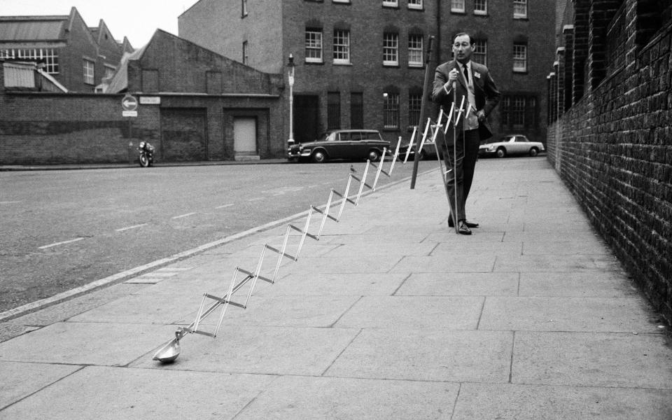 The first London International Inventions Exhibition, held at London's Royal Horticultural New Hall, Westminster. Pictured, an invention that will be a boon to anglers, is this silent ground bait dispenser. A metal cup on the end of an extending arm will place an approximate handful of bait up to 15ft from the operator's position, demonstrated here by the inventor Mr Hugh Knight from Sussex, 6th January 1969. (Photo by Eric Harlow/Mirrorpix/Getty Images)  - Getty