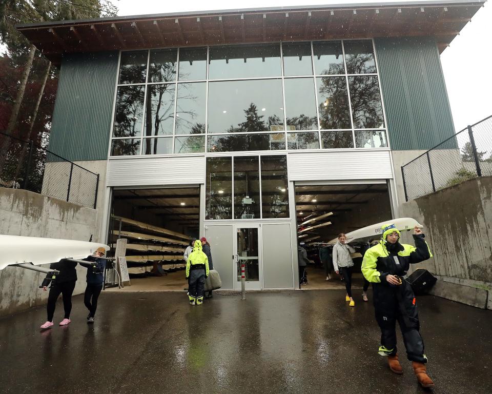 Boats are carried out of the Stan Pocock Legacy Rowing Center as rowers head for Eagle Harbor on a rainy Wednesday, April 20, 2022.