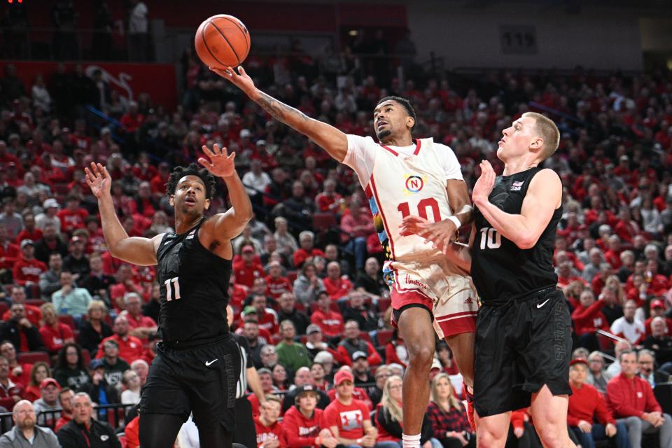 Nebraska guard Jamarques Lawrence scores against Michigan State guard A.J. Hoggard, left, and forward Joey Hauser in the first half on Tuesday, Feb. 28, 2023, in Lincoln, Nebraska.