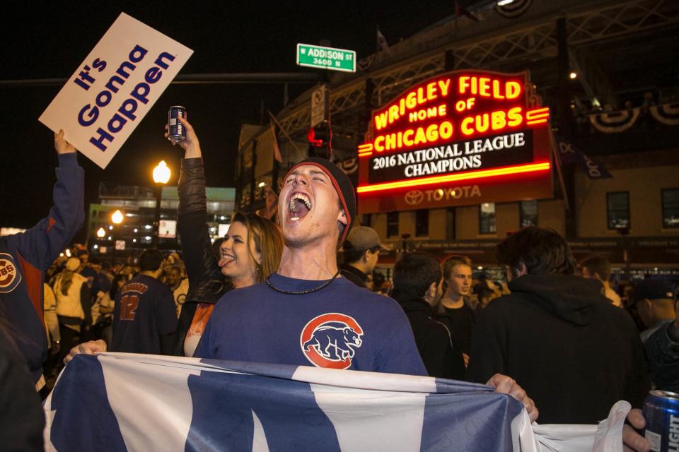 Cubs fans celebrate after winning the NL pennant. (AP)