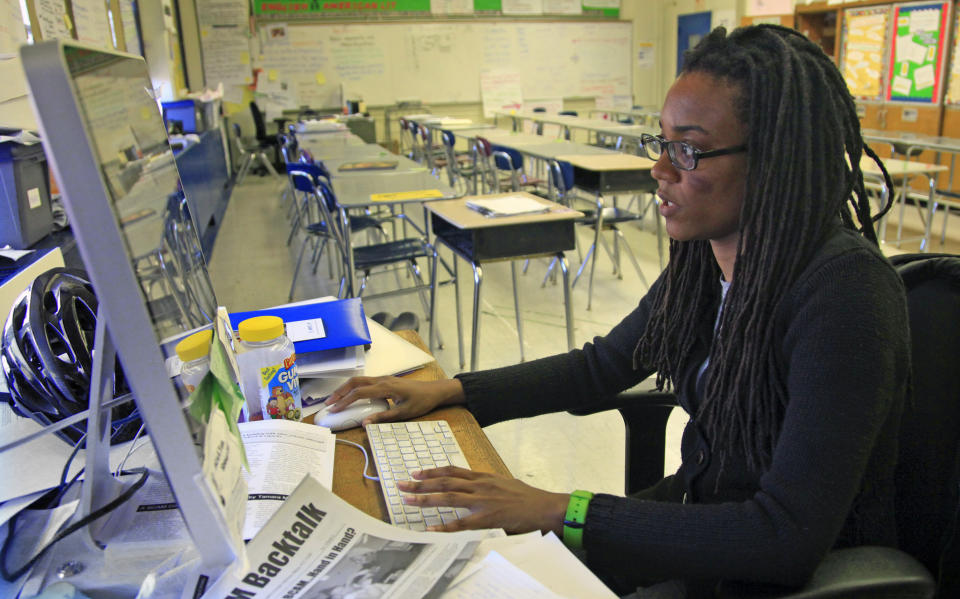 Nkomo Morris, a teacher at Brooklyn's Art and Media High School, works on her classroom computer on Wednesday, April 4, 2012, in New York. Morris, who teaches English and journalism, said she has about 50 current and former students as Facebook friends. That could be a problem if the new rules instruct teachers not to friend students. (AP Photo/Bebeto Matthews)