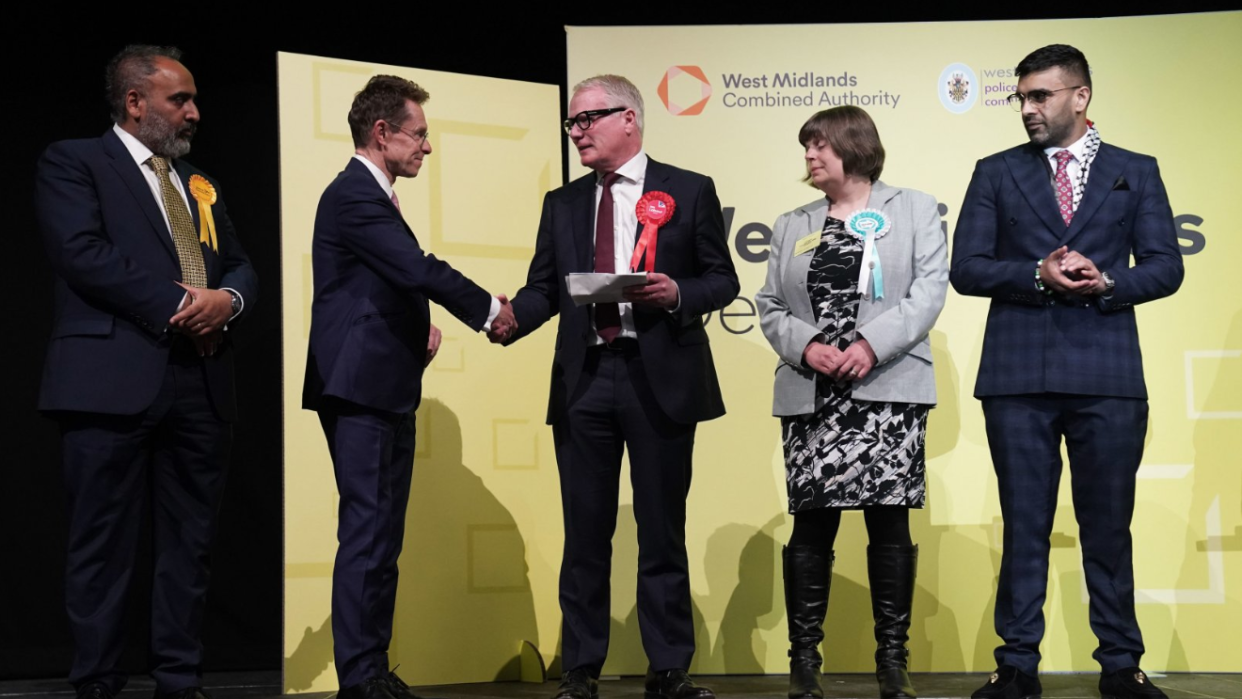 Andy Street shakes Richard Parker's hand alongside the other candidates