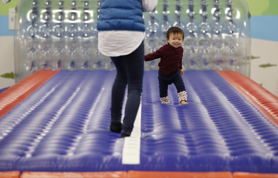 One-year-old Daichi Toyota plays with his mother at an indoor playground which was built for children and parents who refrain from playing outside because of concerns about nuclear radiation in Koriyama, west of the tsunami-crippled Fukushima Daiichi nuclear power plant, Fukushima prefecture February 27, 2014. (REUTERS/Toru Hanai)