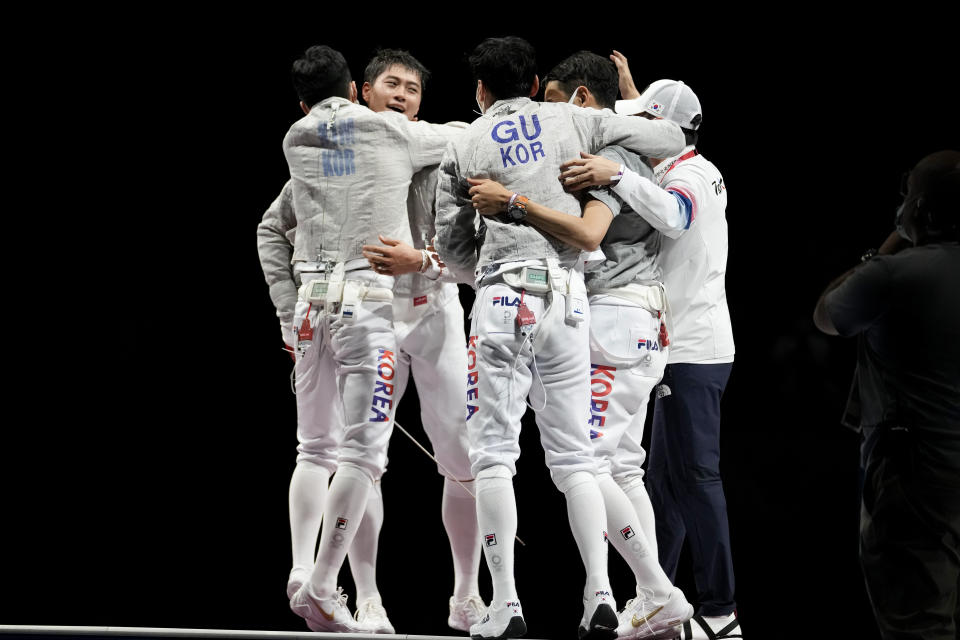 South Korea team fencers celebrate after winning a the men's Sabre team medal at the 2020 Summer Olympics, Wednesday, July 28, 2021, in Chiba, Japan. (AP Photo/Andrew Medichini)