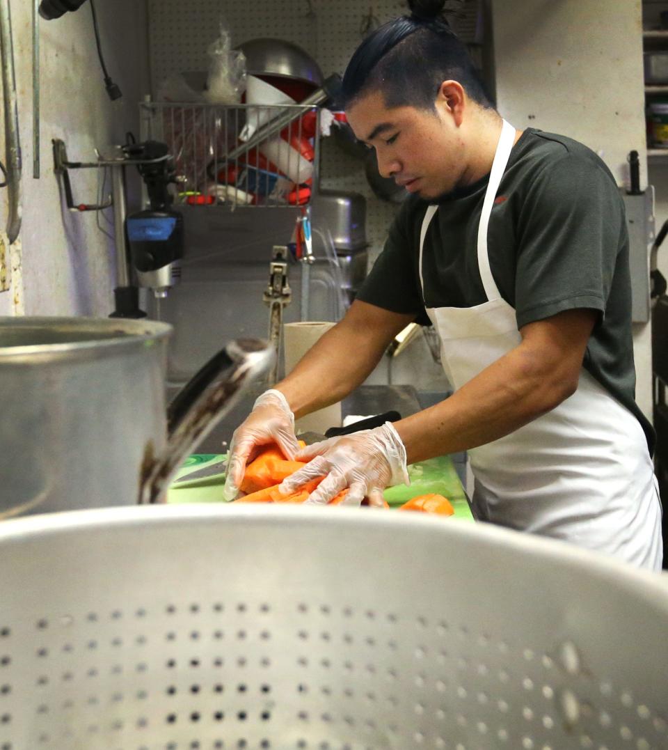 Chef Daniel Lopez chops carrots and celery to help create a chicken dish at Cinco de Mayo Bar & Grill in Dover Monday, July 11, 2022.