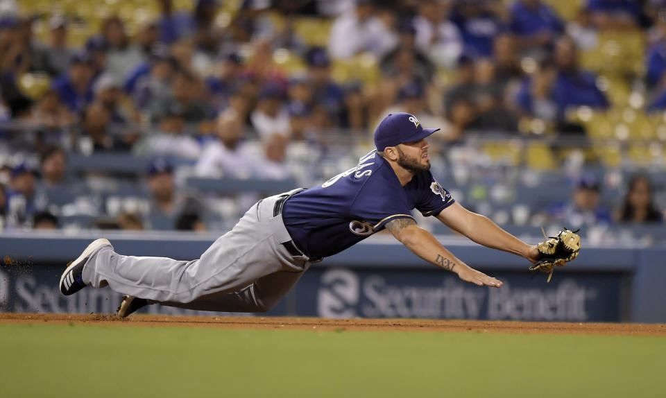 Milwaukee Brewers third baseman Mike Moustakas makes a catch on a ball hit by Los Angeles Dodgers' Enrique Hernandez during the eighth inning of a baseball game Monday, July 30, 2018, in Los Angeles. Hernandez was thrown out at first on the play. Milwaukee won 5-2. (AP Photo/Mark J. Terrill)