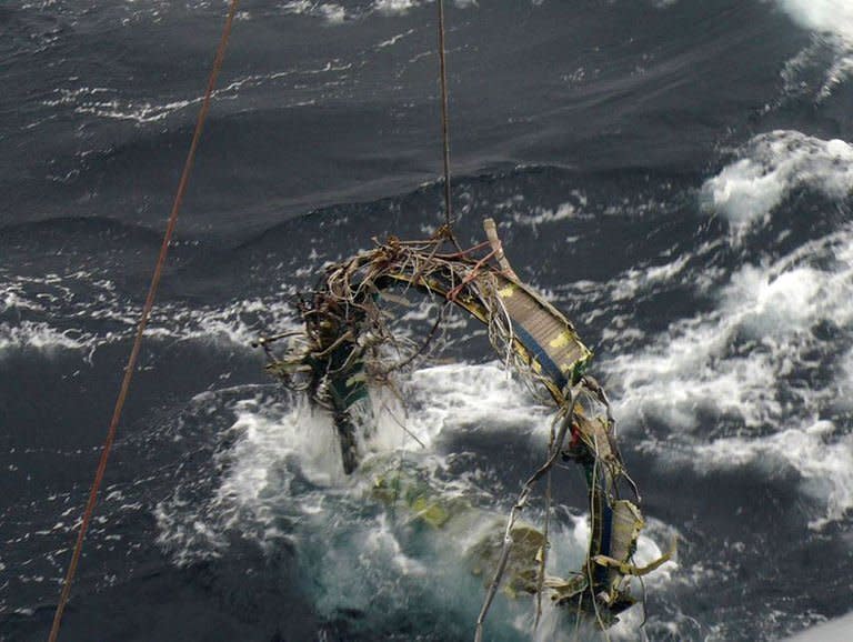 A South Korean Navy vessel on December 23, 2012, recovers debris from North Korea's rocket launch on December 12 in the Yellow Sea. The South's navy later recovered three more pieces of the rocket -- a fuel tank, a combustion chamber and an engine connection rod