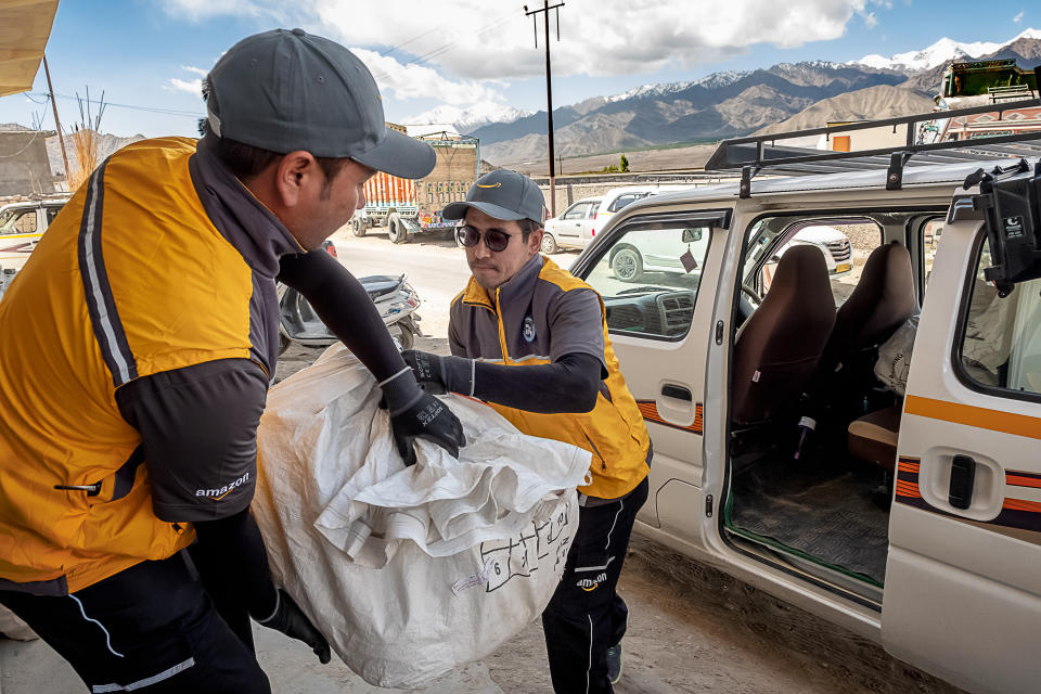 Packages arrive in bags from the airport before they are sorted for door-to-door delivery. (Amazon)