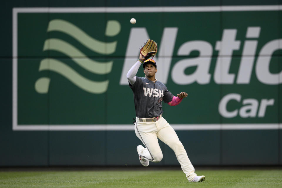 Washington Nationals right fielder Juan Soto makes a catch on a line drive by Atlanta Braves' Austin Riley for the out during the seventh inning of a baseball game, Saturday, July 16, 2022, in Washington. (AP Photo/Nick Wass)