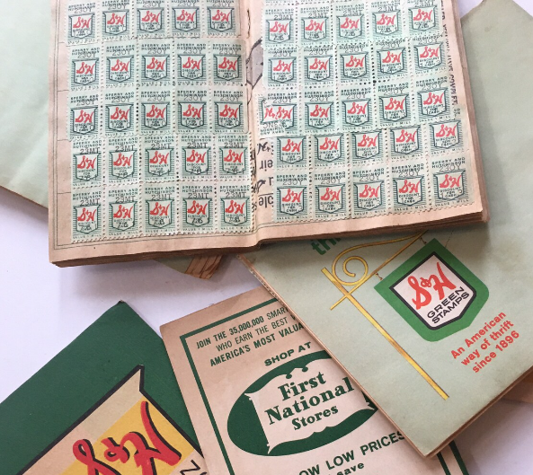 Collection of S&H Green Stamps booklets and trading stamps from the mid-20th century, used for redeeming household items