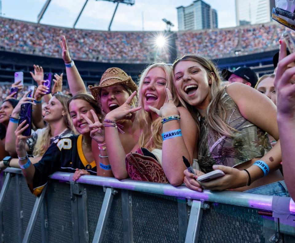 Fans pose for a photo during the Luke Combs concert at Bank of America Stadium on Saturday, July 15, 2023.
