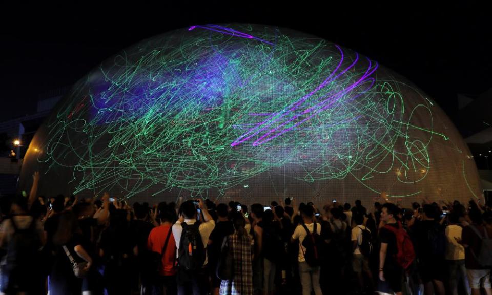 Protesters use laser pointers to light the Hong Kong Space Museum.