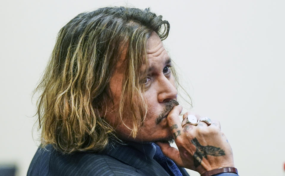 Actor Johnny Depp sits in the courtroom at the Fairfax County Circuit Courthouse in Fairfax, Va., Thursday, April 14, 2022. Depp sued his ex-wife Amber Heard for libel in Fairfax County Circuit Court after she wrote an op-ed piece in The Washington Post in 2018 referring to herself as a “public figure representing domestic abuse.” (Shawn Thew/Pool Photo via AP)