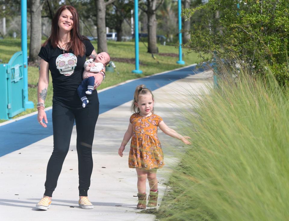 Angela Bennardo said she's pretty tech savvy, but she still had trouble navigating the online system to sign up for Medicaid pregnancy insurance in Florida. She's pictured at Daytona's Riverfront Esplanade last month with her two children, 2-year-old Addi Barry and 6-week-old Hendrix Barry.