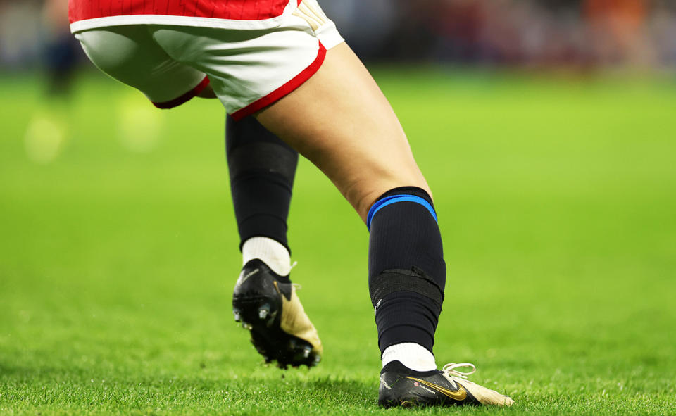 An Arsenal player, pictured here wearing black Chelsea socks and blue take over the Nike logo.
