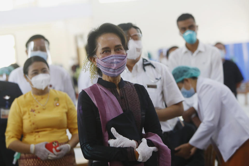 Myanmar leader Aung San Suu Kyi inspects and watches the vaccination processes to health workers at a hospital Wednesday, Jan. 27, 2021, in Naypyitaw, Myanmar. Health workers in Myanmar on Wednesday became the country's first people to get vaccinated against COVID-19, just five days after the first vaccine supply was delivered from India. (AP Photo/Aung Shine Oo)