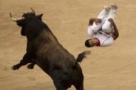 <p>A recortador, or “bull-leaper,” competes at the San Fermín festival in Pamplona, Spain, July 11, 2015. (AP Photo/Andres Kudacki) </p>