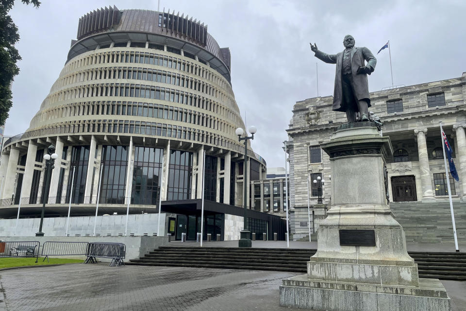 FILE - The Parliament buildings stand in the central business district of Wellington, New Zealand, Friday, Aug. 27, 2021. On Friday, Dec. 23, 2022, The Associated Press reported on stories circulating online incorrectly claiming New Zealand intelligence officials published a booklet asking people to report friends or family members who are critical of coronavirus-related policy measures as terrorists. (AP Photo /Nick Perry, File)